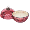 Pink textured candle holder with a candle inside on a white background