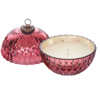 Pink textured candle holder with a candle inside on a white background