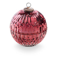 Pink glass ornament with textured surface on a white background
