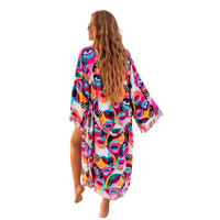 Woman wearing colorful Karli Buxton Picasso print organic cotton kaftan on the beach
