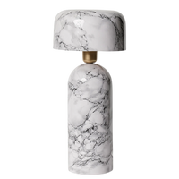 Marble-patterned lamp with gold base on a white background