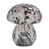 Glass mushroom-shaped object with marbled pattern on a white background