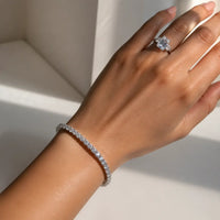 Anna Zuckerman Avery 10 Carat Tennis Bracelet with round Diamond Crystalline stones and a signature center-stone link clasp in platinum-plated brass.
