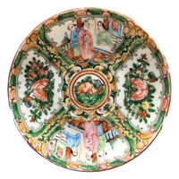 Decorative ceramic plate with colorful designs of people and animals on a white background