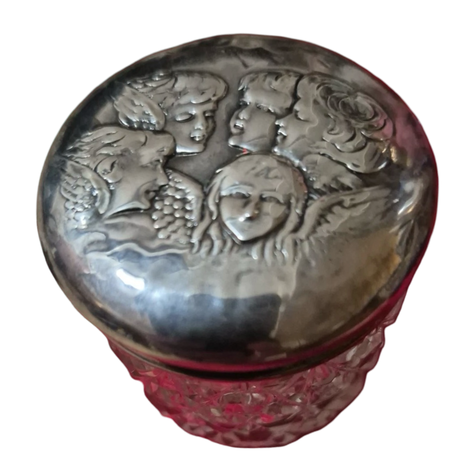 Decorative container with silver lid featuring embossed faces and red base on a white background