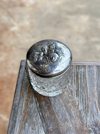 Close-up of a metal door handle on a wooden door