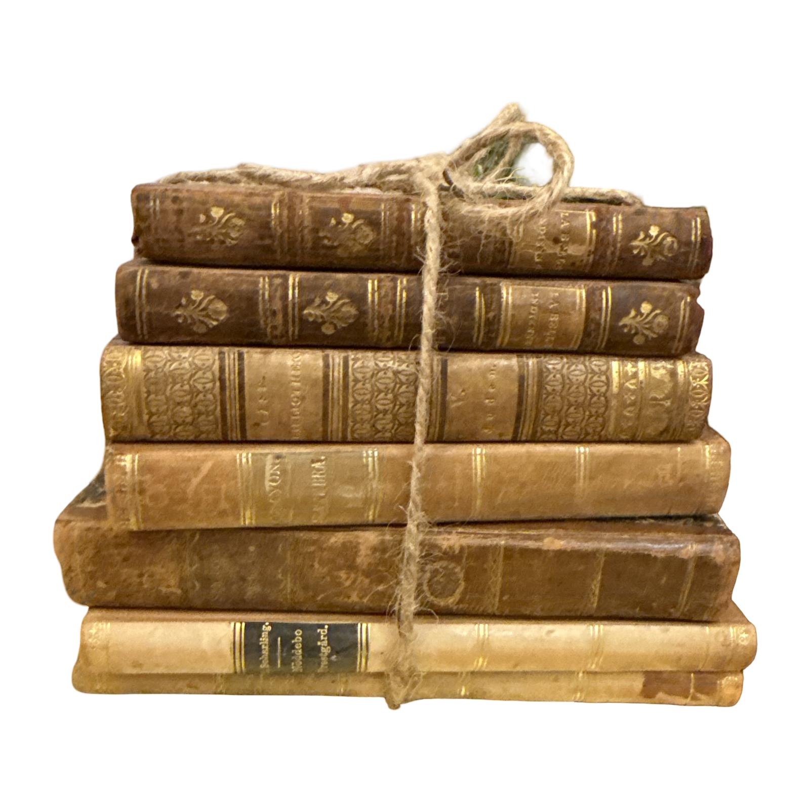 Stack of old books tied with twine on a white background