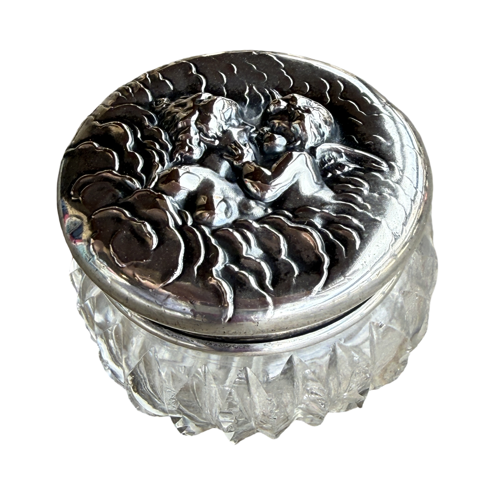 Decorative glass container with silver lid featuring angel design on a white background