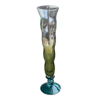 Tall glass vase with ribbed design on a white background