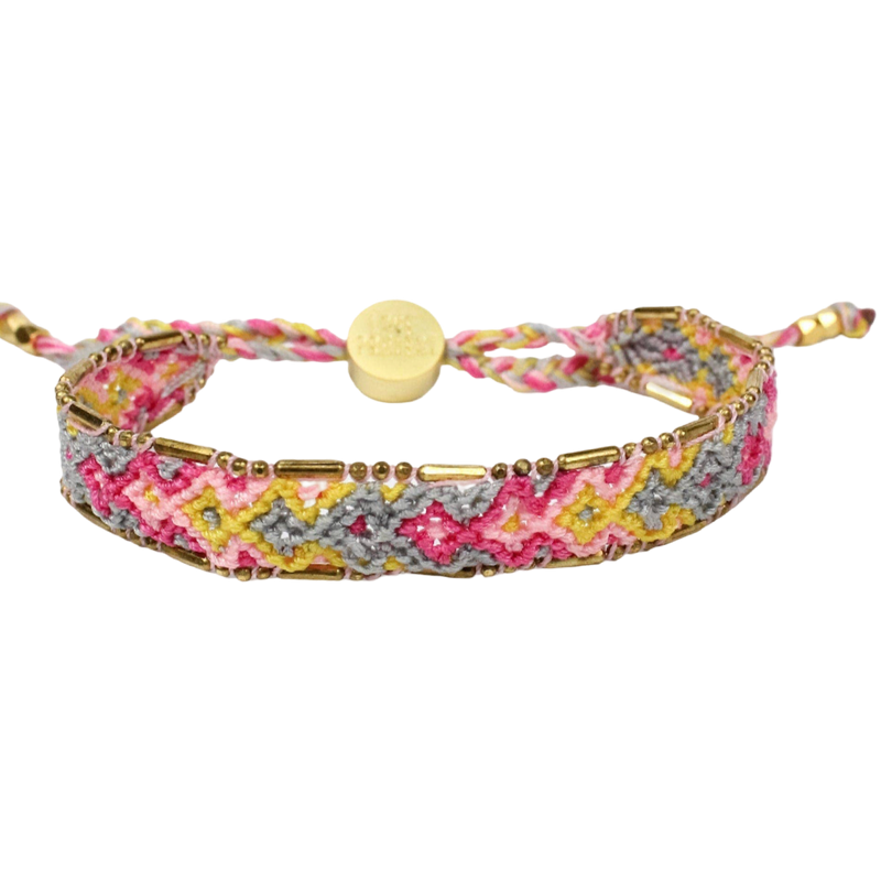 Multicolored braided bracelet with gold accents on a white background