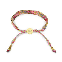 Multicolored braided bracelet with a gold clasp on a white background