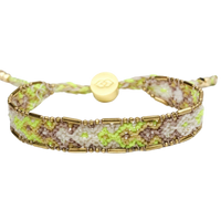 Bracelet with gold accents and green pattern on a white background