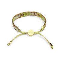 Bracelet with green and brown pattern on a white background