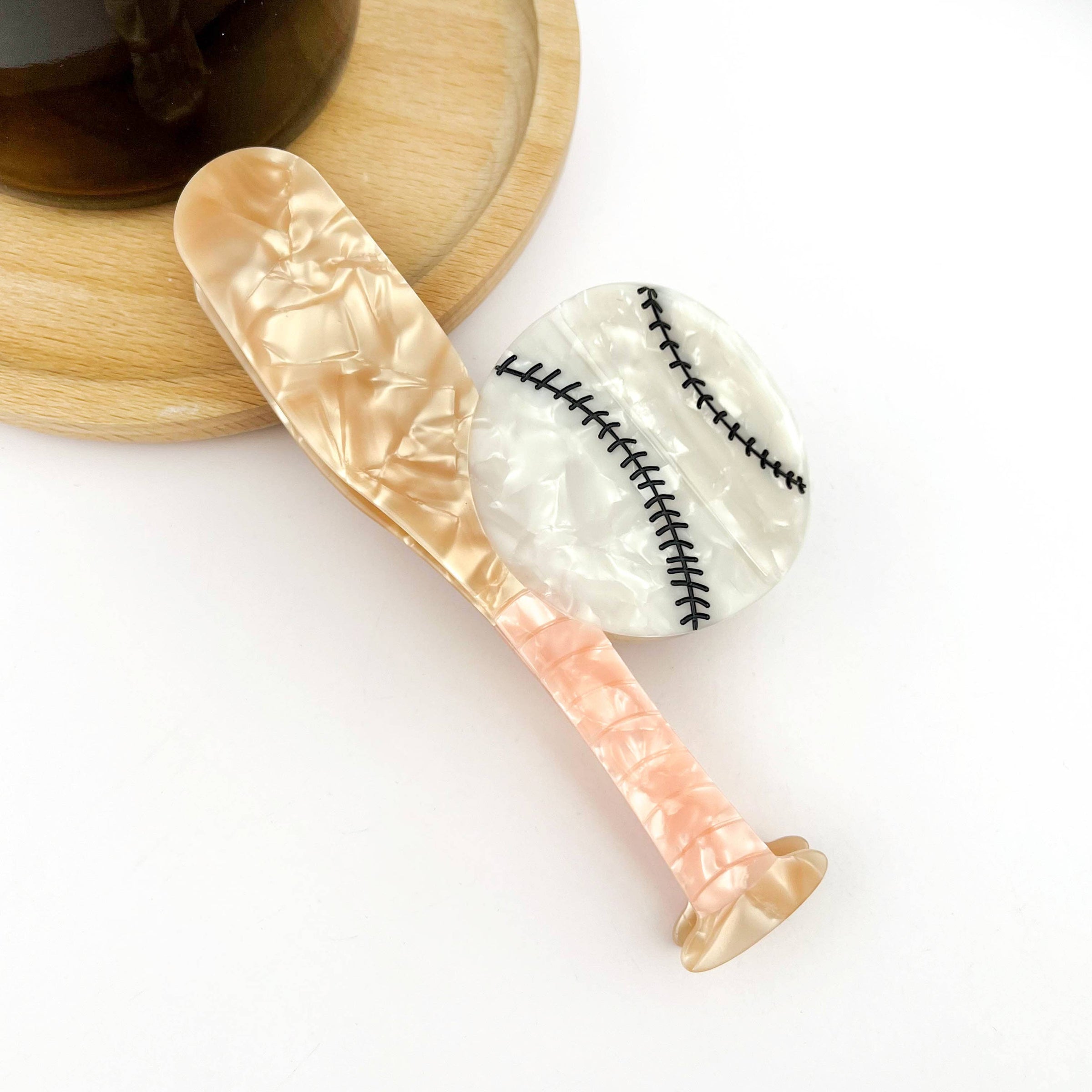 Baseball-inspired acetate claw clip designed as a playful game-day hair accessory.