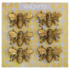 Gold bee-shaped magnets on a patterned card
