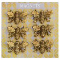 Gold bee-shaped magnets on a patterned card