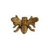Bronze bee-shaped object on a white background