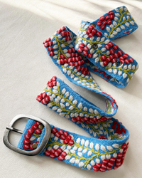 Bright blue embroidered wool belt with dimensional red berries, white leaves, green vines, and a lead-free metal buckle.