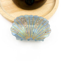 Blue-gray acetate shell-shaped claw clip decorated with sparkling rhinestones.