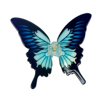 Blue acetate large butterfly-shaped hair claw clip with sculptural wings and a secure claw closure.