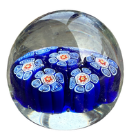 Glass paperweight with blue and white pattern on a white background