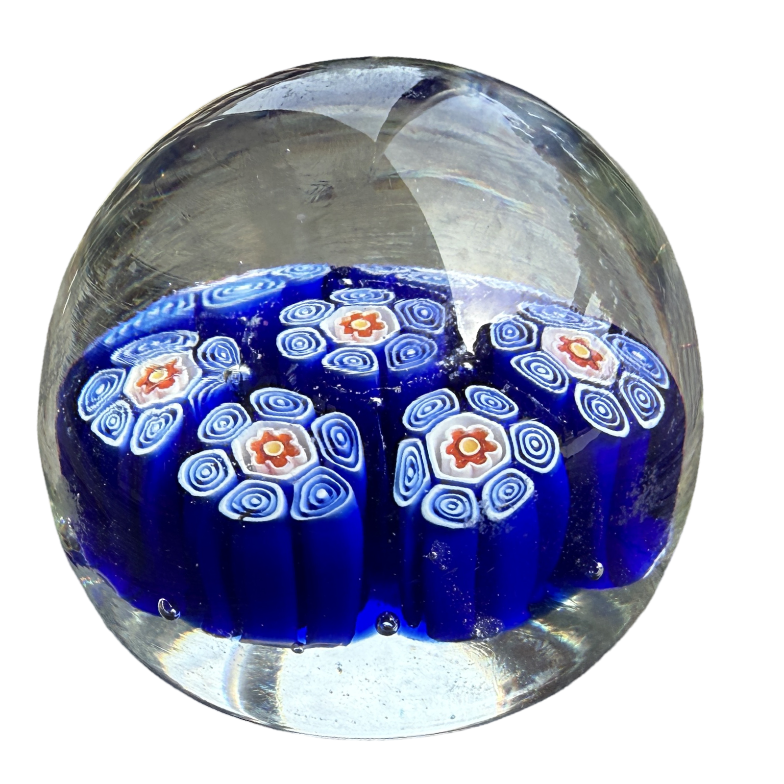 Glass paperweight with blue and white pattern on a white background