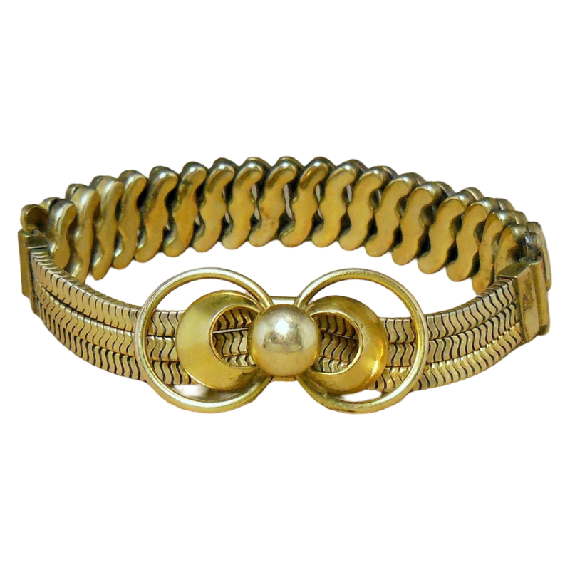 Gold bracelet with a decorative clasp on a white background