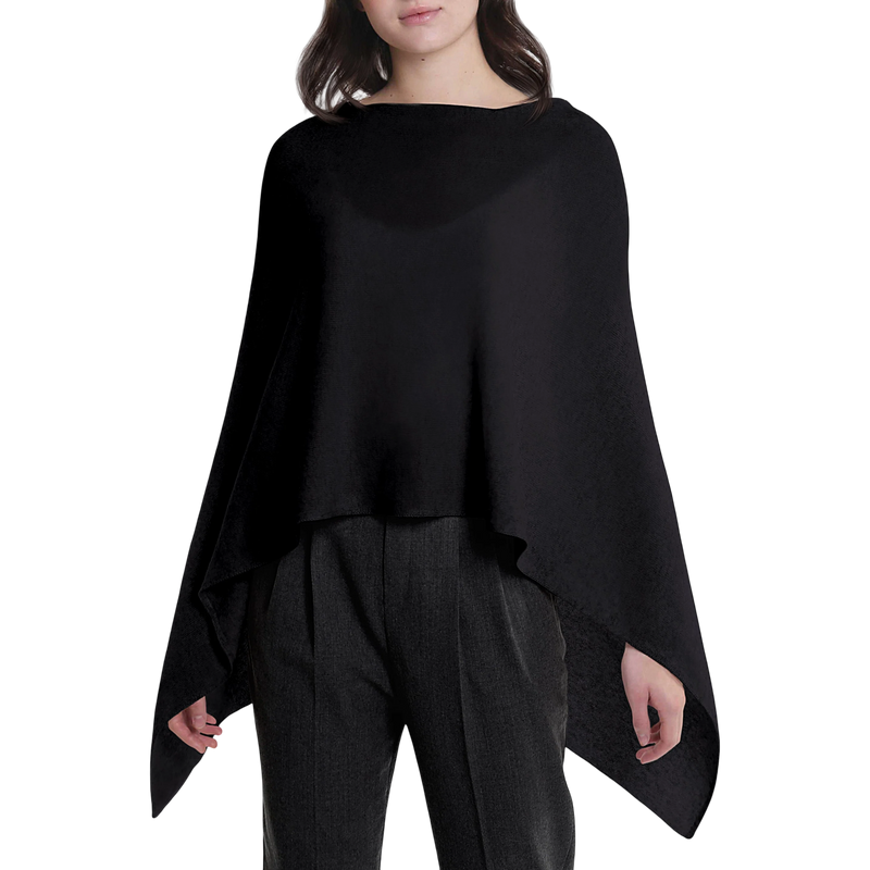 Person wearing a black poncho over a plain background