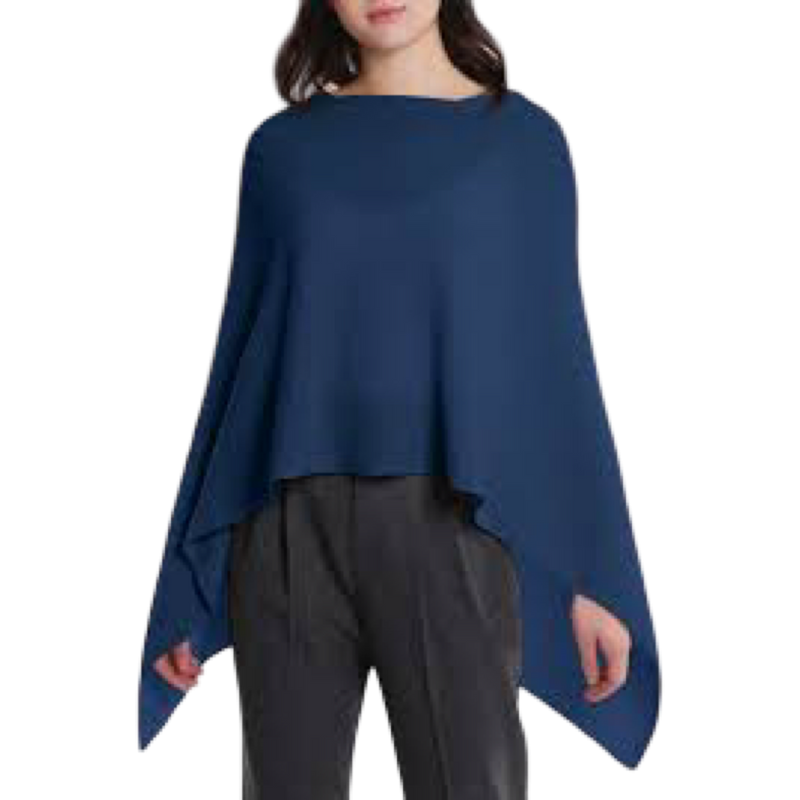 Woman wearing a blue poncho over a black outfit on a white background
