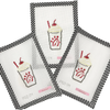 Four cross-stitched designs of a milkshake with red straw on white fabric, framed by black and white striped borders.