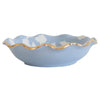 Blue ceramic bowl with floral pattern and gold rim on a white background