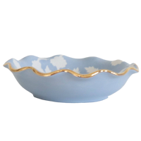 Blue ceramic bowl with a gold rim on a white background