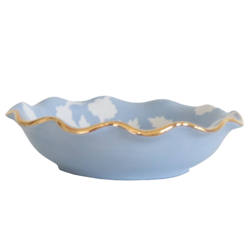 Blue ceramic bowl with a gold rim on a white background