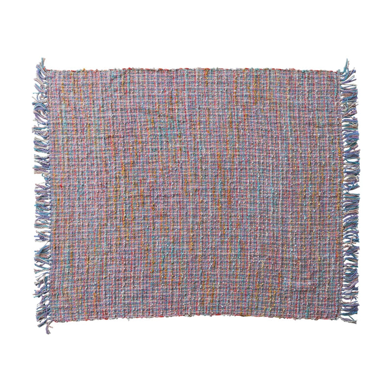 Multicolored woven placemat with fringes on a white background