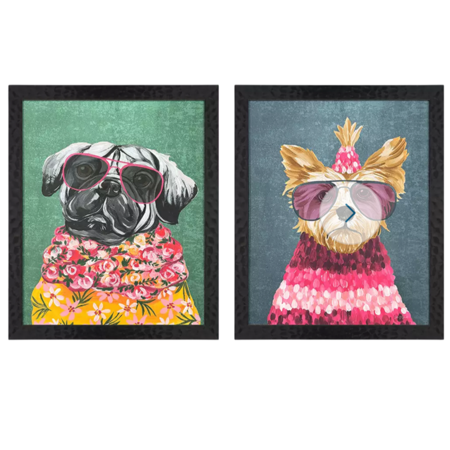 Two framed illustrations of dogs wearing colorful outfits on a white background