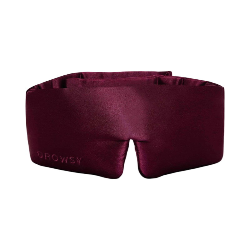 Maroon sleep mask with 'Drowsy' branding on a white background