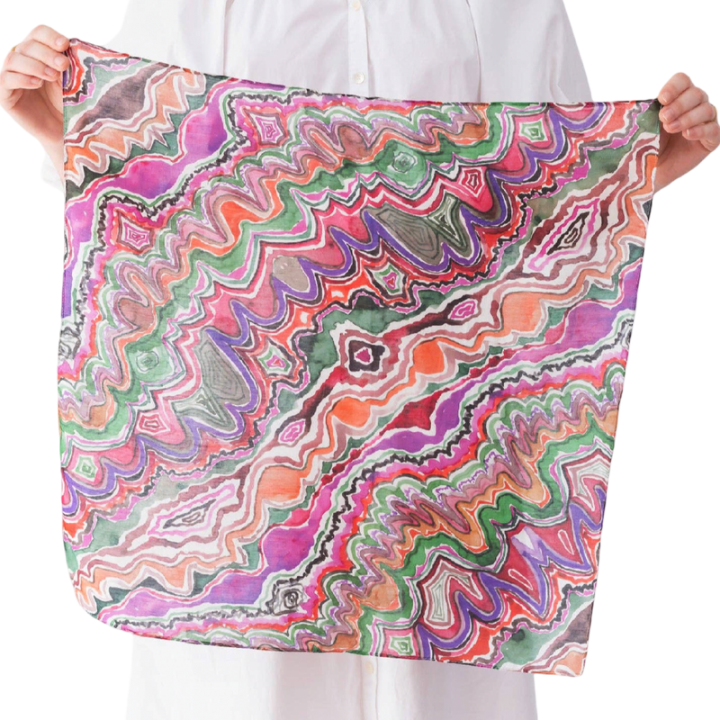 Person holding a colorful patterned scarf