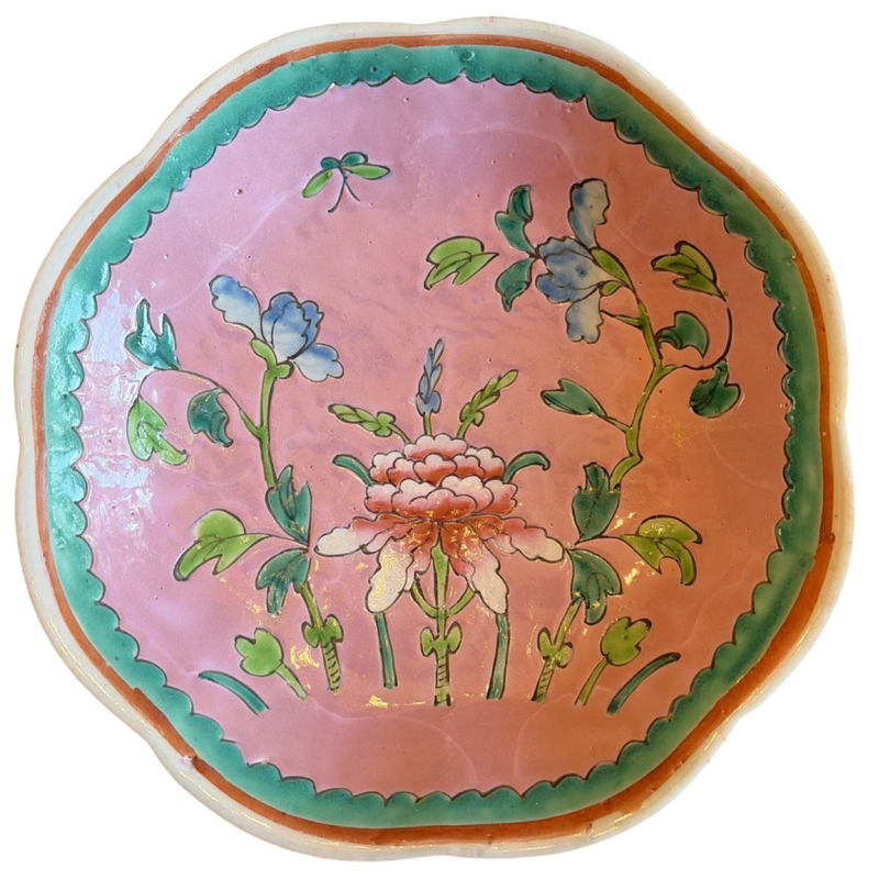 Decorative ceramic plate with floral design on a pink background