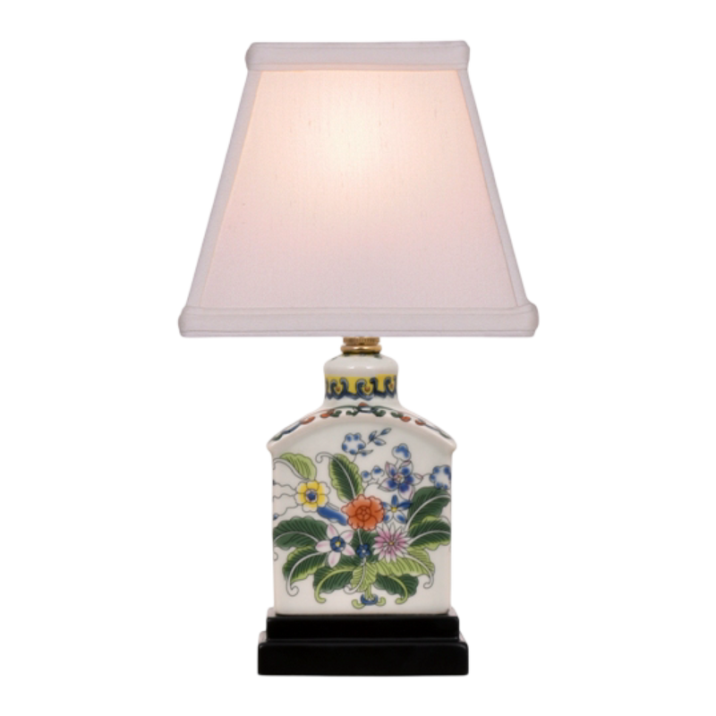 Decorative table lamp with floral design on a white background