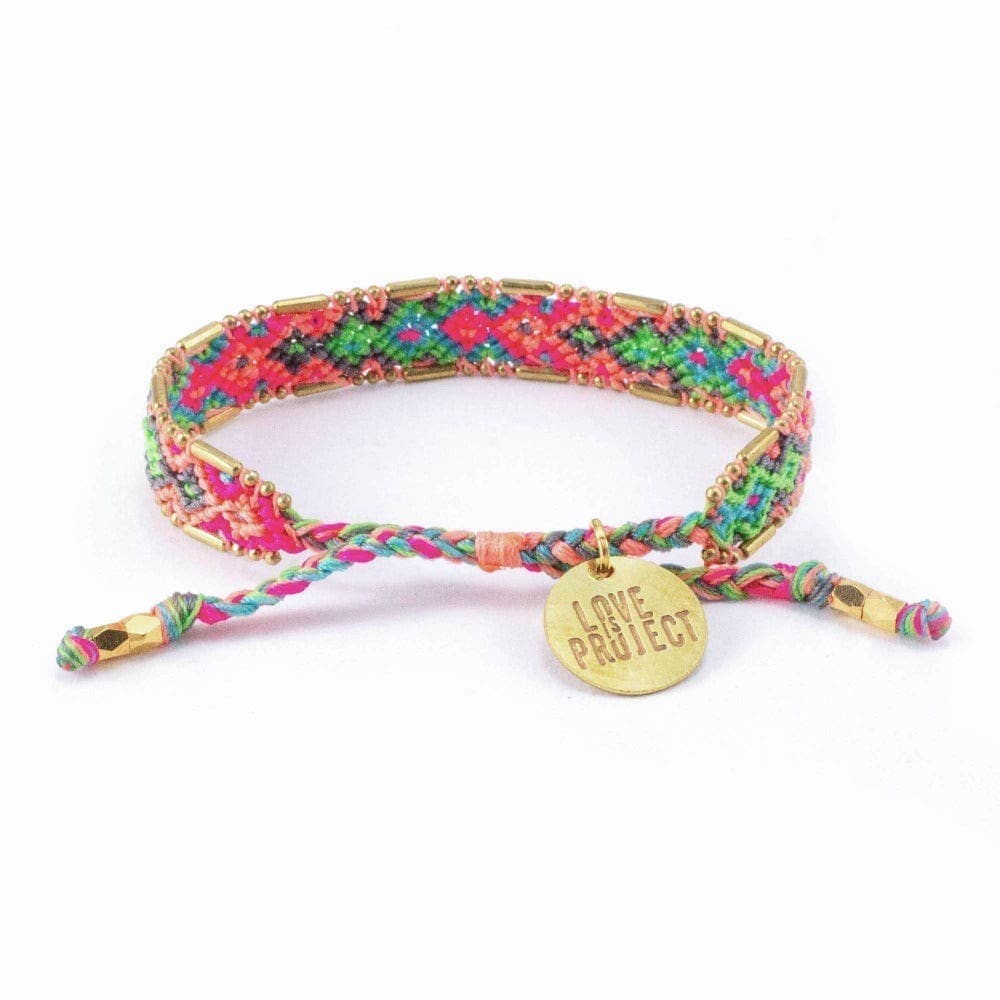 Colorful braided bracelet with a gold tag on a white background