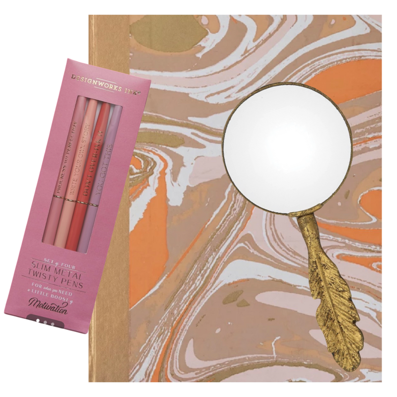 Set of lip pencils in a pink box with a decorative mirror on a marble background