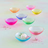 Set of colorful glass bowls on a gradient background