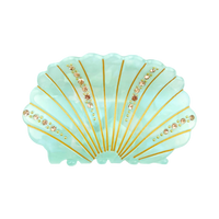 Green acetate shell-shaped claw clip decorated with sparkling rhinestones.