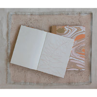 Open notebook with blank pages on a textured surface
