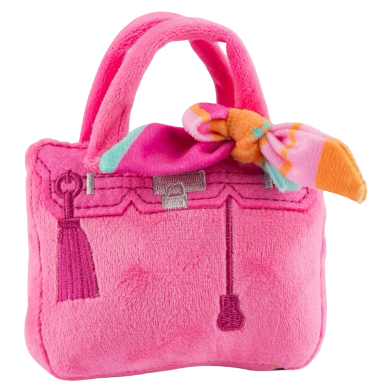 Pink plush handbag with a bow on a white background