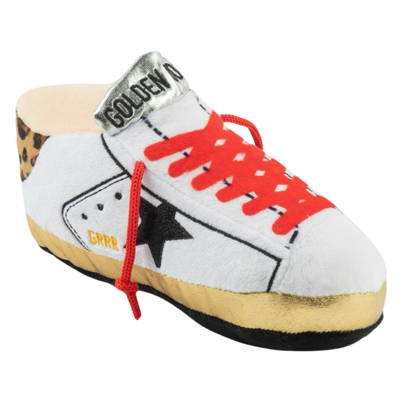 White sneaker with red laces and a black star on a white background