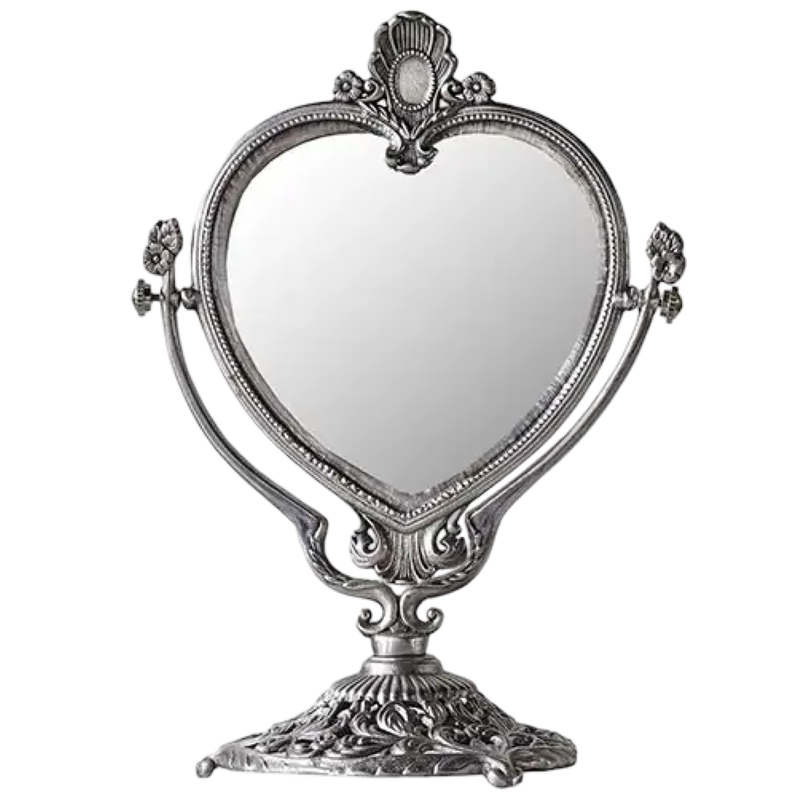 Decorative heart-shaped mirror with ornate frame on a white background
