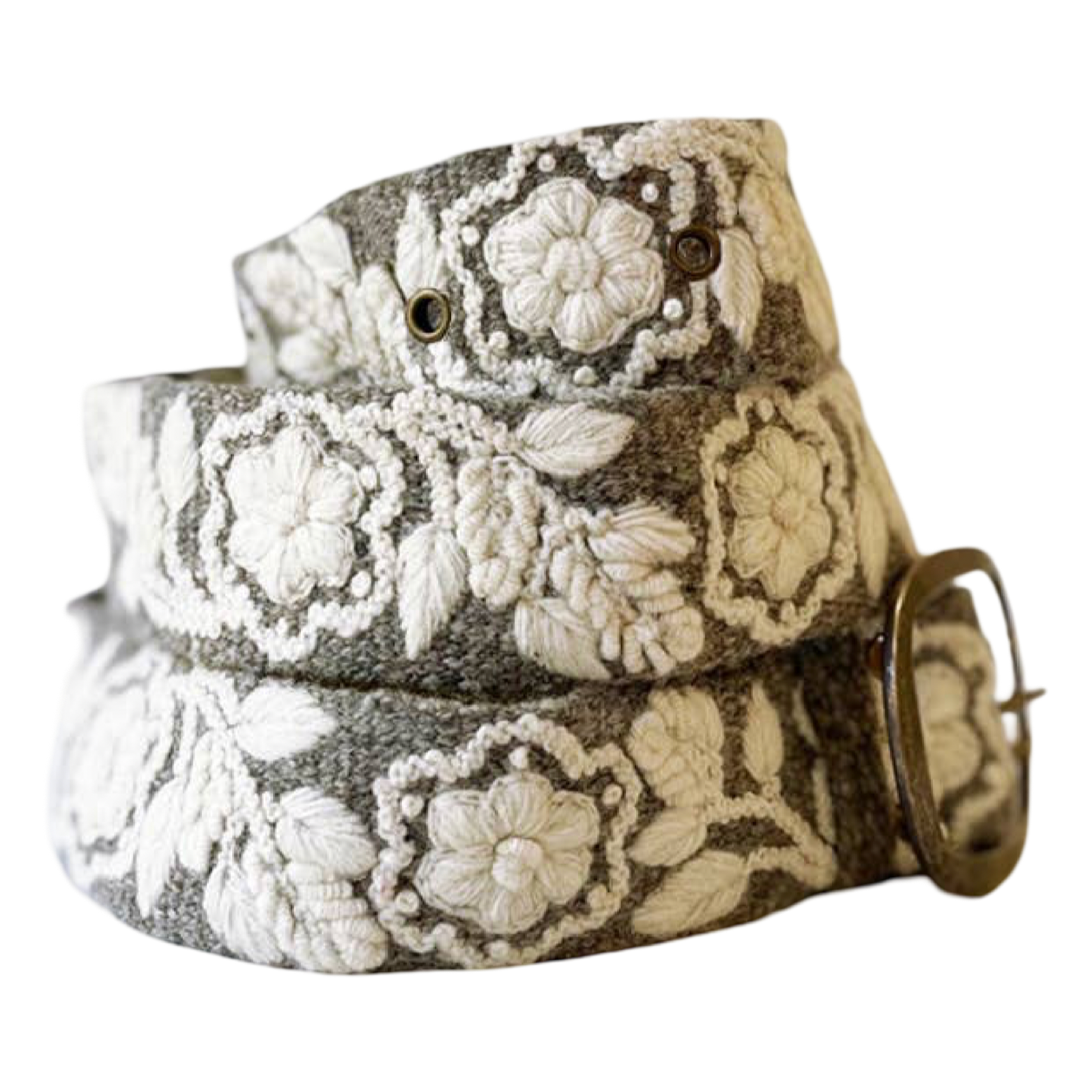 A woven belt with a textured gray base and raised off-white floral embroidery, finished with a brass buckle.