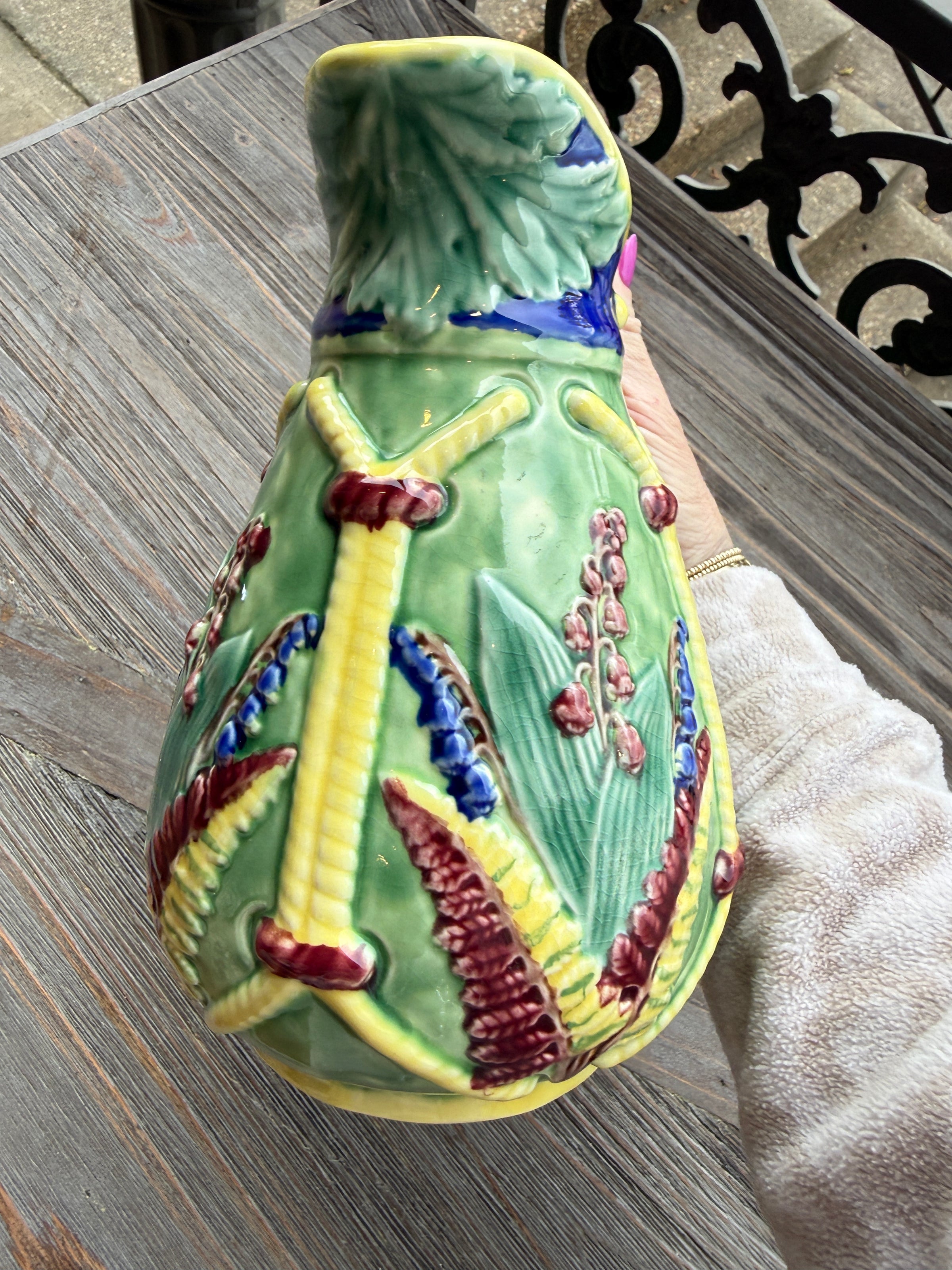 Decorative ceramic fish with colorful patterns on a wooden surface