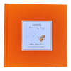 Orange book with a blue label featuring text and illustrations on a white background